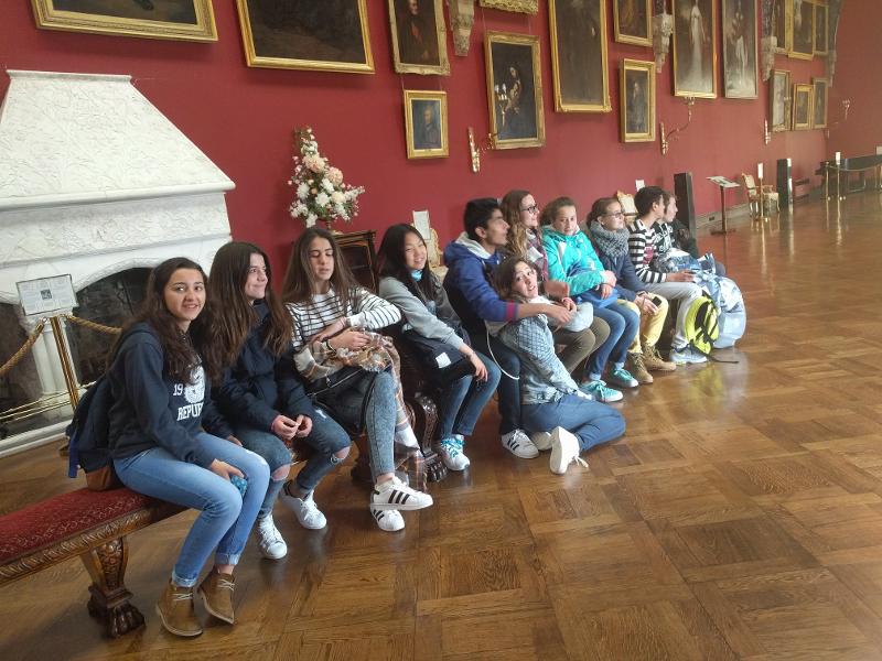 Grupo de jovens sentados numa galeria de arte durante um curso de ingles irlanda.