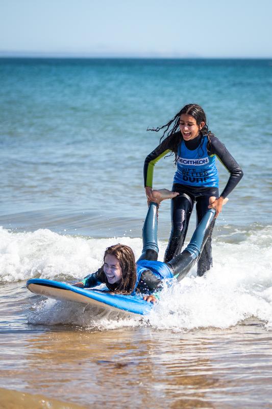 duas meninas em momento divertido na aula de surf no surf camp Carcavelos