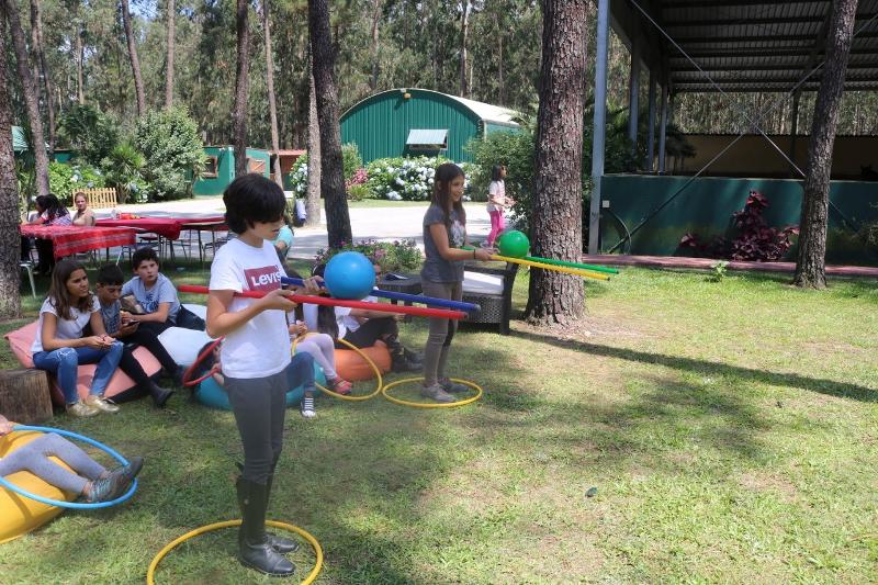 Dinâmicas de grupo entre vários participantes no jardim do campo de férias