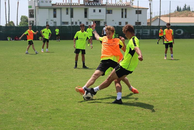 Jogadores fazem jogo de treino no campo de férias de futebol