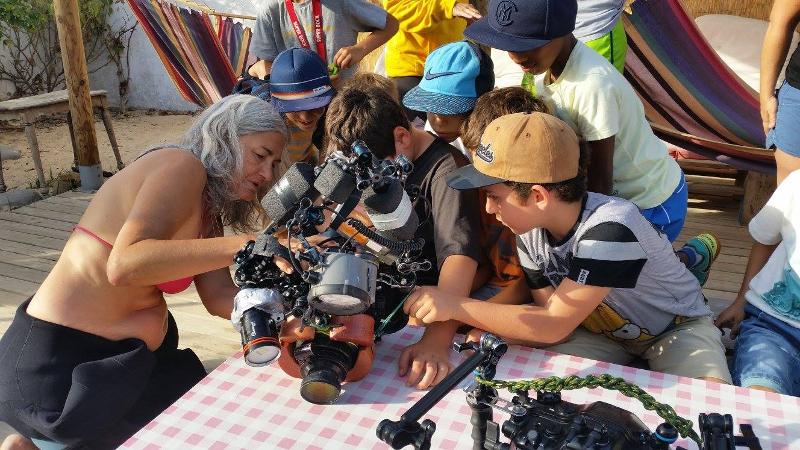Participantes a aprender mais sobre o material no campo de férias de mergulho