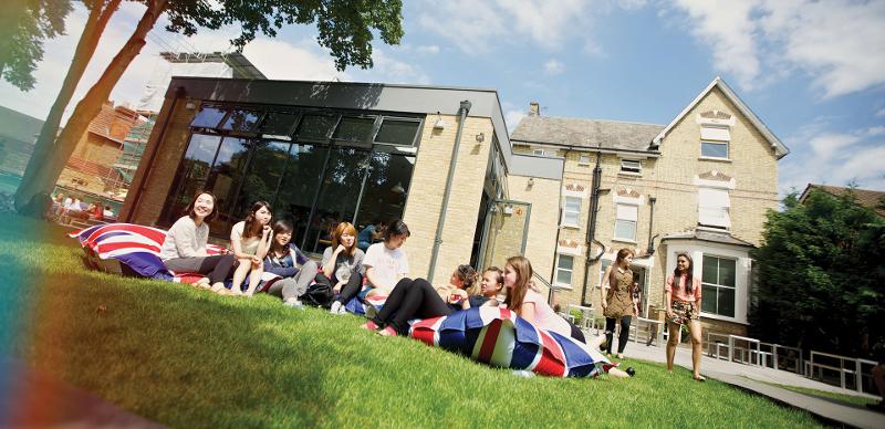 Grupo de jovens relaxando no exterior, aproveitando um momento de convívio e diversão durante o curso de lingua inglesa.