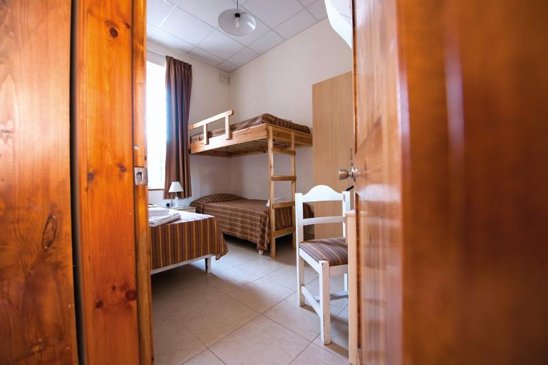 Quarto simples com uma cama de beliche e uma cama individual, perfeito para descansar durante o teu curso de linguas na alemanha.