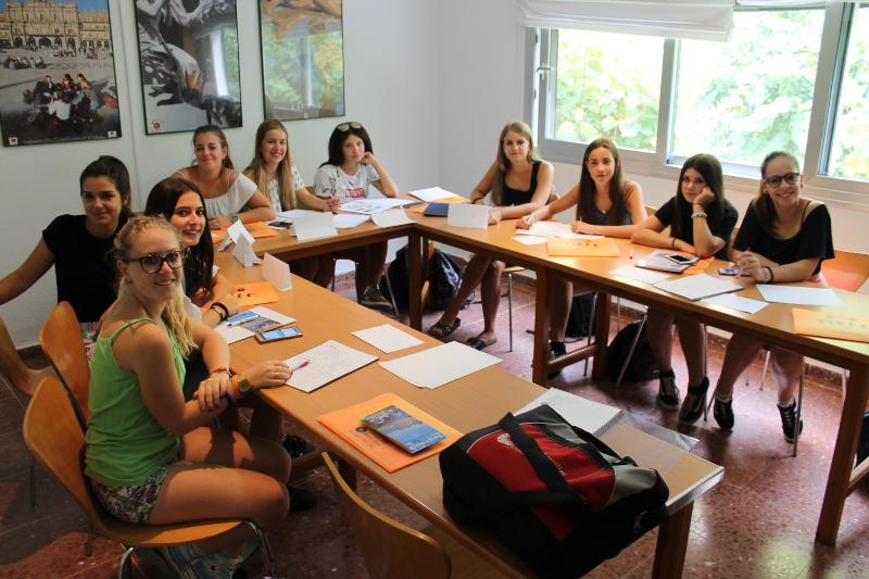 Grupo de estudantes sentados numa sala de aula, participando nos cursos de linguas em espanha.