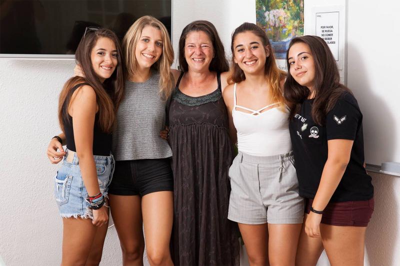 Cinco raparigas felizes e sorridentes a posar para uma fotografia durante o curso de linguas verao